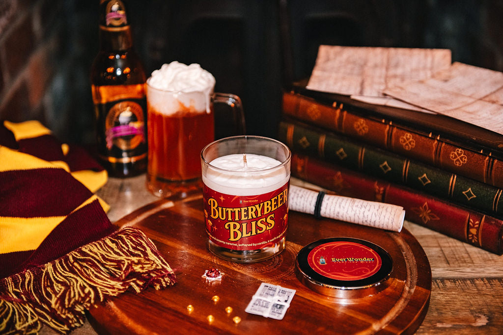 Butterybeer Bliss candle with a wizarding background